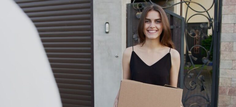 A satisfied customer holding a moving box.