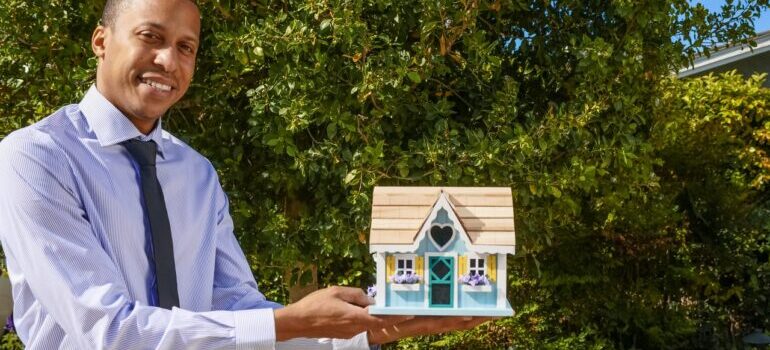 Man holding a model house