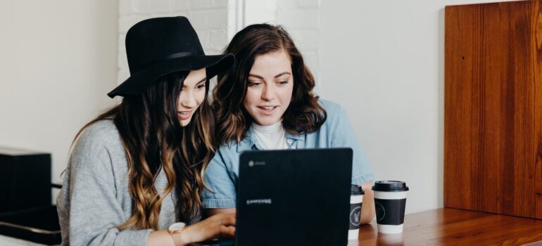 two women looking at a laptop