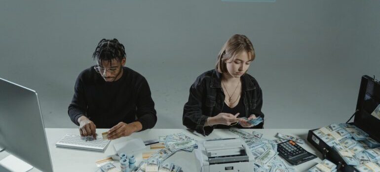 Guy and girl counting a lot of money.