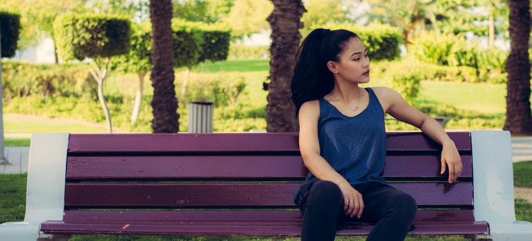 A woman is sitting on a bench.
