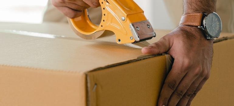 a person taping a box