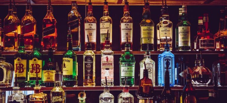 An empty bar with a lot of alcohol bottles