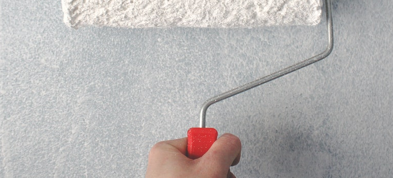 a person repainting walls as one of the Low-cost home improvement ideas