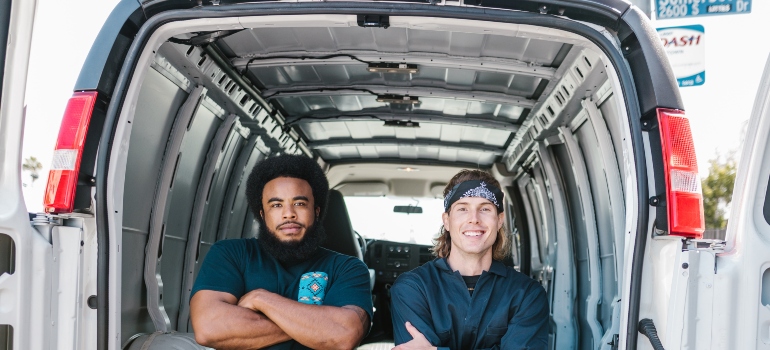 two movers sitting in their van