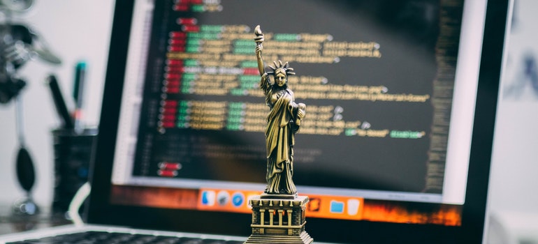 Miniature Statue of Liberty in front of MacBook.