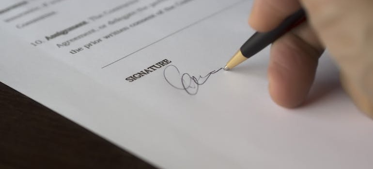 A person signing contract.